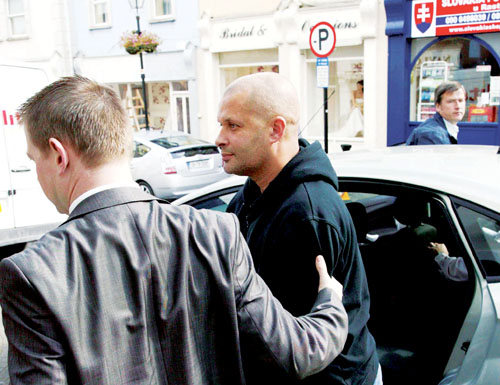 John Harris (45) from Clara is led into Athlone District Court yesterday (Thursday) by Detective Sergeant Eamon Curley, where he faced firearm and theft charges in relation to an armed robbery of the sub-post office in Irishtown on Wednesday (September 16) which ended after an 80km car chase up the motorway.