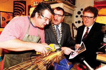 Pictured (l-r): Silversmith Edward Cook brings the new Continental Irish Car of the Year trophy to life with Michael Moroney , chairman of the  Irish Motoring Writers’ Association, and Paddy Murphy, general manager of Continental Tyres Ireland, looking on. 
