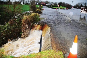 A road or a waterfall — the main N18 road was turned into a raging torrent after a ditch was removed on Tuesday, endangering nearby houses and angering householders. Pic: Burren Photography