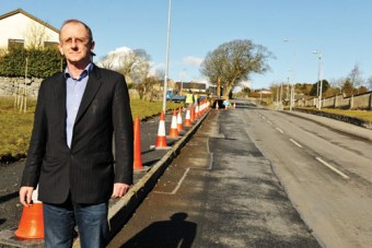 Never mind the bollards — Cllr Cameron at the site of the new footpath this week.