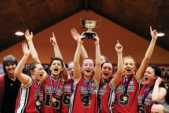 Calasanctius College Oranmore team captain Carol McCarthy lifts the cup as her teammates celebrate a third successive victory in the u-19A girls’ All-Ireland Schools Basketball League finals.