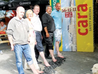 Testing the hot coals for the forthcoming firewalk are Dean Boyce, Galway Taxis, Sharon Fitzpatrick, Cancer Care West, Gerry Molloy and Leo Murphy, Galway Taxis, and Pat Lonergan, O Connells Bar.