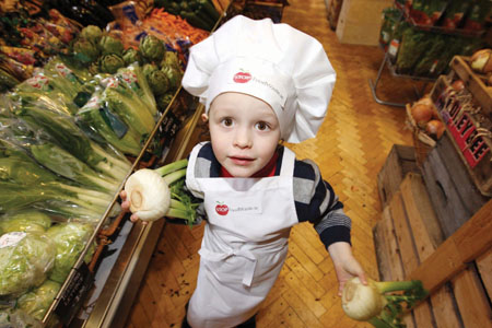 Three-year-old Mark Power gets to grips with the fruit and veg on offer at the launch of the EPA’s STOP Food Waste programme.