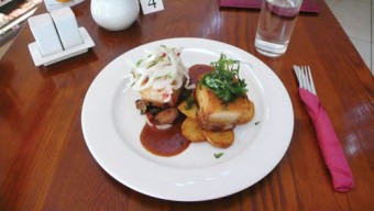 Peruvian style pork belly served with onion salsa and fried potatoes.