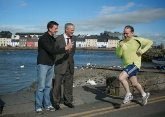 On your marks: Cllr Michael Crowe warms up for the Galway City Bay Half marathon which takes place on Saturday in aid of Cancer Care West watched by Ciar&aacute;n Hayes, director of services, Galway City Council and race director, Ray O'Connor.  Photo:-Mike Shaughnessy
