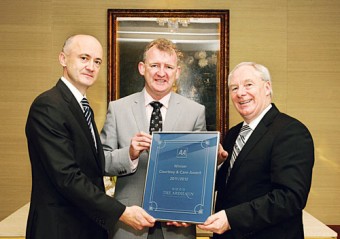 John Ryan of The Ardilaun hotel being presented with the award of AA Ireland Courtesy & Care Award by Minister of State at the Department of Transport, Tourism & Sport Michael Ring, and Brendan Nevin, CEO of AA Ireland.