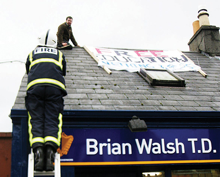 The scene at Brian Walsh's office yesterday when a protestor climbed onto the roof.