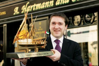 Richard Hartmann with the gold dhow presented by Abu Dhabi Sailing & Yacht Club. Photo:-Mike Shaughnessy