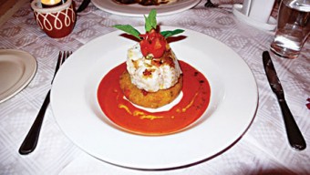 Panfried fillet of cod filled with crabmeat and smoked salmon mousse served on a potato cake and a creamy tomato butter.