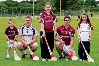 Galway senior hurler Joe Canning and Galway senior hurling captain Fergal Moore receive support from young Galway hurling fans (L to R) Andrew Canning, Lily Lynch and Kayleigh Slevin as they get ready for their weekend clash against Cork. 
Photo: David Ruffles