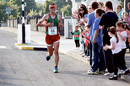 Running for victory: Straide’s John Byrne heads for the finish line in Irishtown.
