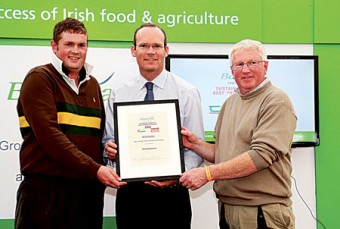 Minister for Agriculture, Food, and the Marine Simon Coveney presents the Sustainable Quality Beef Producer Award for Weanling/Store to Beef Production, to winner Richard Bournes, along with Chris Bournes, at the National Ploughing Championships. Photo: Patrick Browne.