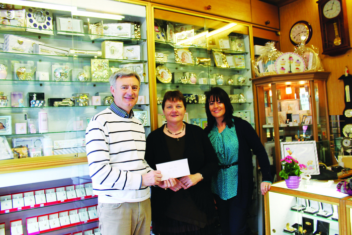Pat Whelan Mullingar Chamber president, and Angie Daly, Mullingar Chamber, present Geraldine Farrington - who created the winning window - with her prize.