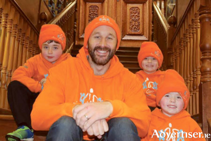 Roscommon actor Chris O’Dowd wearing orange with George, Isaac, and Archie
