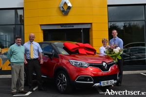 Ann Carter from Westport who picked up the keys to her tenth new Renault from JJ Burke in Ballinrobe is presented with flowers and gift voucher by the garage. Left to right: Peter Carter, Joseph Burke (sales manager), Ann Carter, and Paul McGuinness (sales executive).