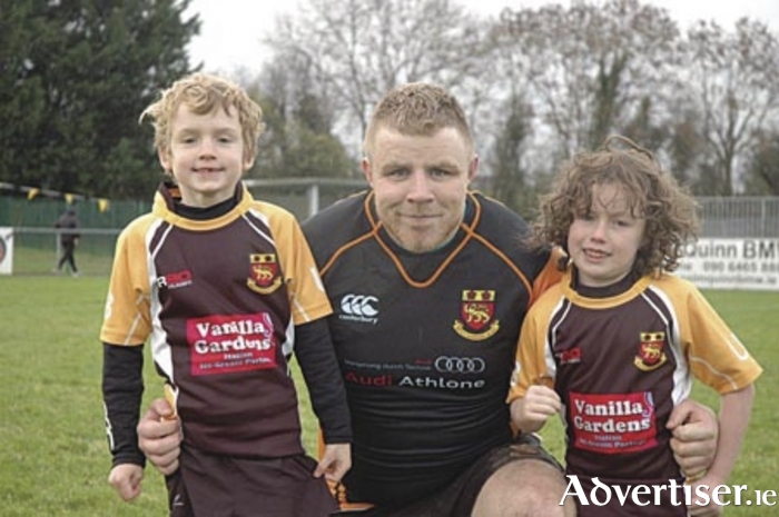 Mascots Colm Forde and Arthur Drummond pictured with Buccaneers captain Martin Staunton prior to the game against Trinity 
