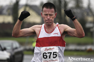 Gerry Carty of GCH celebrates victory at the Kiltullagh 10k.