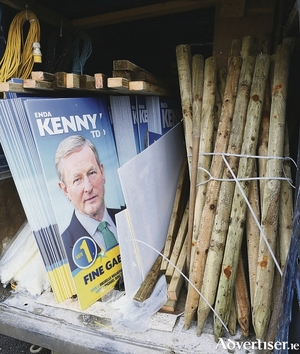 From the van to the pole: Campaign workers were busy putting up election posters this week. Photo: Michael Donnelly 