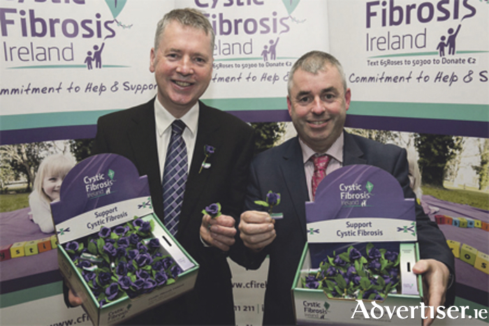Fergal Smyth, fundraising manager with Cystic Fibrosis Ireland, is pictured with Athlone’s Kevin Boxer Moran at the launch of Cystic Fibrosis National Awareness Week and 65 Roses Day. The fundraiser takes place on Friday, April 15, and will see volunteers selling purple roses nationwide to raise €65,000 for services for people with cystic fibrosis. 
Photo: Shane O’Neill Photography