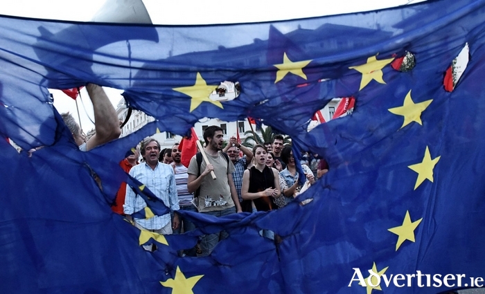 Protesters burn a European Union flag during a protest in the northern Greek port city of Thessaloniki, last year.