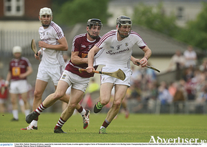 Padraic Mannion of Galway, supported by teammate Jason Flynnn, shrugs off Aonghus Clarke of Westmeath in the Leinster GAA Hurling Senior Championship quarter-final in TEG Cusack Park, Mullingar.
 