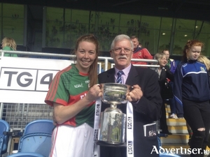 Mayo captain Sarah Tierney receives the CBE Cup from Connacht President Liam Costigan in MacHale Park. Photo: Mayo LGFA 