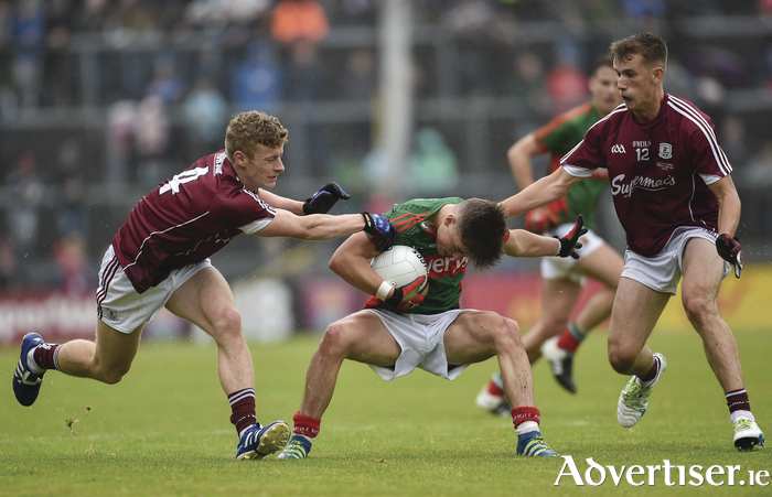 Men and ball: Colm Moran tries to protect the ball against two Galway men. Photo: Sportsfile