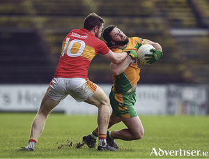 Conor Cunningham of Corofin is tackled by Fergal Durkan of Castlebar Mitchels.