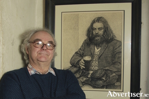 Johnny Finn, with a portrait of his late brother Mickey. Photo:- Mike Shaughnessy