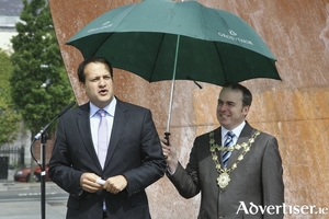 Leo Varadkar speaking in Galway in 2011, and protected from any inclement weather by Fianna F&aacute;il&#039;s Michael Crowe. Photo:- Mike Shaughnessy