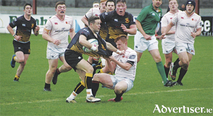 Buccaneers fullback Alan Gaughan brushes off the tackle of Dublin University's Tommy Whittle
