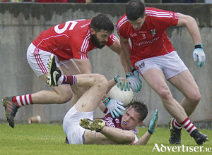 Annaghdown&#039;s Adam Quirke comes under pressure from Tuam Stars Seamus Kelly and Paul Collins in action from the opening round of the Senior football Championship games at Tuam Stadium on Sunday.
Photo:-Mike Shaughnessy