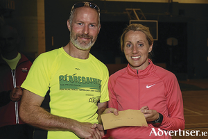 Brendan Dunleavy of The Arches Claregalway, main race sponsor, with winner Regina Casey. 