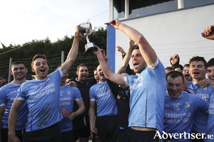 Niall Burke and Gear&oacute;id McInerney lift the Connacht Intermediate hurling title in Athleague (Roscommon) on Saturday. Pic by Joe Keane.   