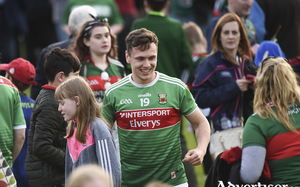 The long road for the hardcore fans: Michael Plunkett makes his way off the field through happy Mayo supporters who made the long trek to Newry last Saturday evening. Photo: Sportsfile 