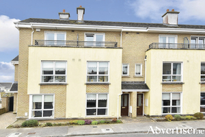 Four bedroom mid terrace property in the Roscam development.