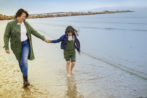 Maura Farragher, lead practitioner at Enigma Wellness Clinic pictured walking Silverstrand Beach with her daughter Amy age 9. Photo: Julia Monard