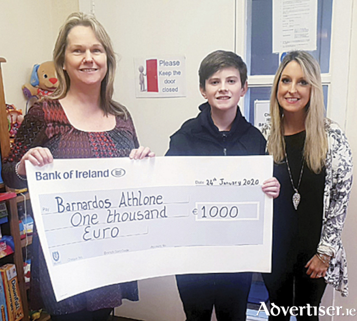 Local artist, Anna Boles, is pictured with her son Jake Newman as she makes a cheque presentation to Catherine from Barnardos, the proceeds of her Athlone 2020 calendar sales
