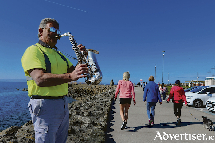 Sax on the Beach - Galway musician Alan Nolan adding some musical cheer to The Prom on Wednesday after Galway City Council lifted parking restrictions along the seafront ahead of promised spell of fine weather this weekend. Photo:-Mike Shaughnessy
