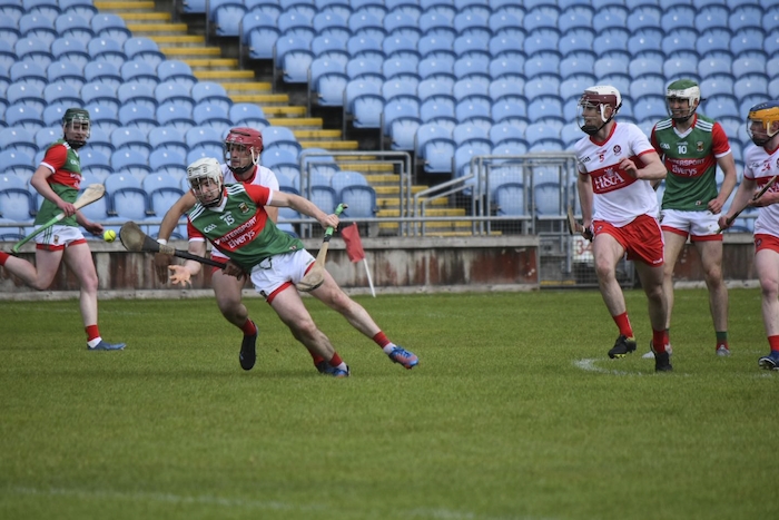 Steady Shane: Shane Boland tries to get the ball away under pressure from a Derry defender. Photo: Mayo GAA. 