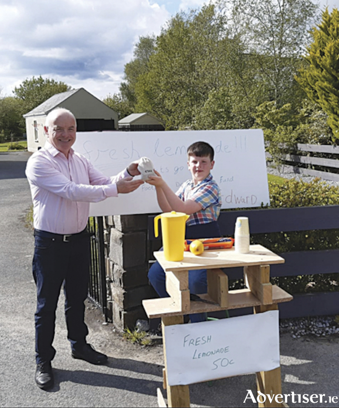 Young Moydrum entrepreneur, Edward Moore, raised funds for a local road safety cause during the May Bank Holiday weekend.  He is pictured with local Fianna Fail Councillor, Frankie Keena

