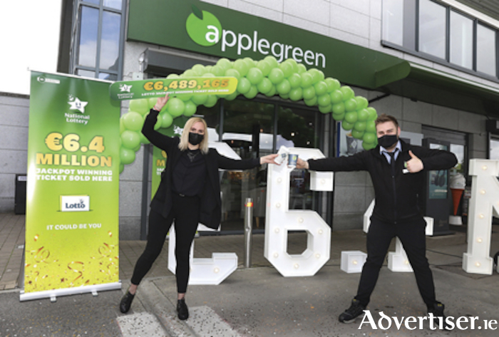Michael Jenkins, Assistant Manager, Applegreen and Vaida Ekaminaviciute, Applegreen, are pictured in jovial mood following confirmation that the winning Lotto jackpot ticket was sold at the Applegreen service station in Arcadia Retail Park. Pic: Mac Innes Photography.