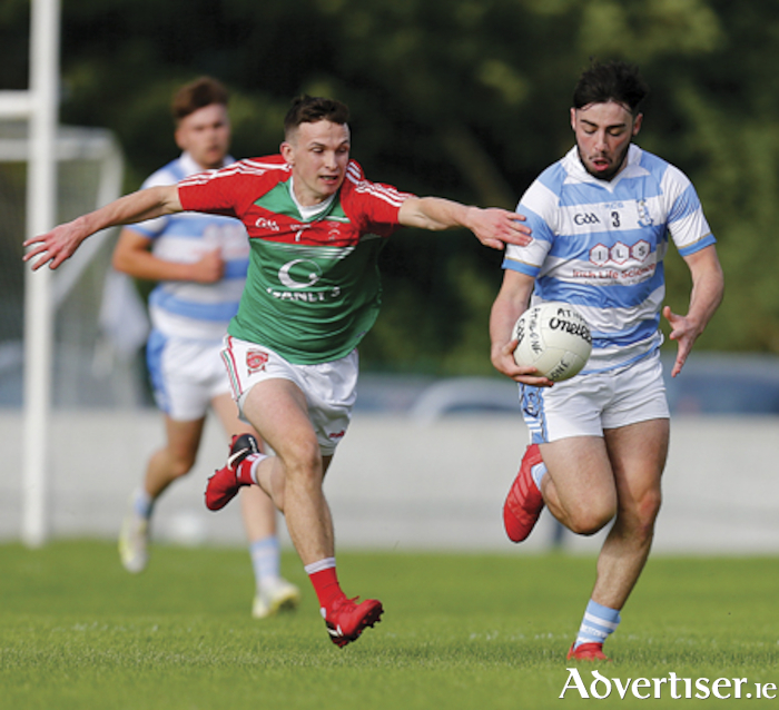 .Athlone’s James Finlass evades the challenge of Garrycastle’s Mark McCallon, during the team’s drawn Westmeath senior football championship fixture in Tubberclair on Sunday evening.  Photograph by AC Sports Images.