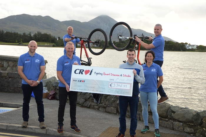 Pictured are the cyclists involved, from left: Brian Hyland (Westport), Padraig McLoughlin (Newport), Colin Loughney (Hollymount) and Rachel Nolan (Ballina). Front: Padraig Marrey presenting the cheque to Paul Cunnane (Croí Communications Officer).