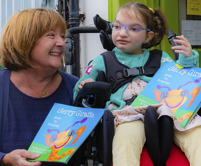  Valerie Judge, author, and Ava Kenny, with copies of 'Gerry The Giraffe Goes To Hospital'. 