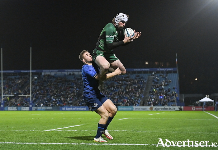Leap of faith: Mack Hansen of Connacht catches the ball ahead of Leinster's Jordan Larmour on his way to scoring his side's first try during the URC match between Leinster and Connacht at the RDS Arena in Dublin. Photo by Ramsey Cardy/Sportsfile