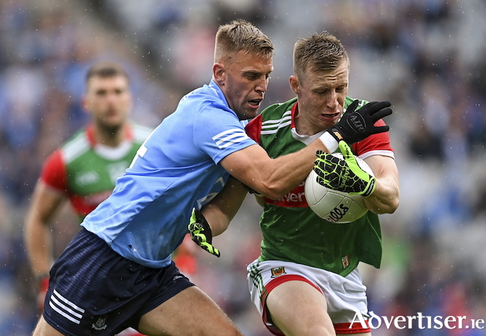 Ryan on the run: Ryan O'Donoghue tries to evade the clutches of Jonny Cooper in last year's All Ireland semi-final clash between Mayo and Dublin. Photo: Sportsfile. 