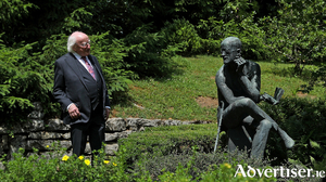 President Michael D. Higgins with the distinctive image of Joyce, by the  sculptor Milton Hebald which marks the Joyce grave at Fulturn Cemetery, Zurich. Nora is buried with her husband, as is their son Giorgio, and his second wife Asta Jahnke-Osterwald. 