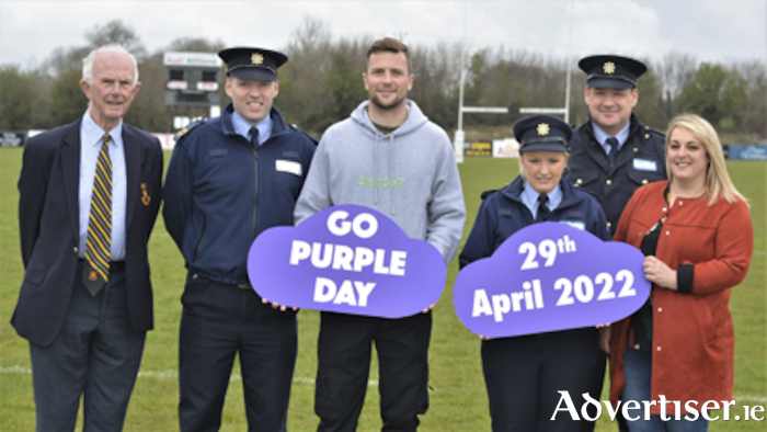 Promoting ‘Go Purple Day’ at Dubarry Park, the home of Buccaneers RFC, were, l-r, Michael Cleary (Hon.Sec.Buccaneers RFC), Garda John Hickey, Connacht captain and Ireland international Jack Carty, Garda Stacey Looby, Sergeant Paul Kelly and Deirdre Berry (Esker House Refuge Centre). 