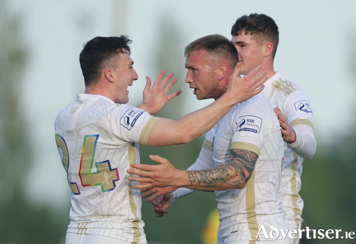 The brilliant Stephen Walsh celebrates with Ed McCarthy and Alex McCarthy at Ferrycarrig Park.